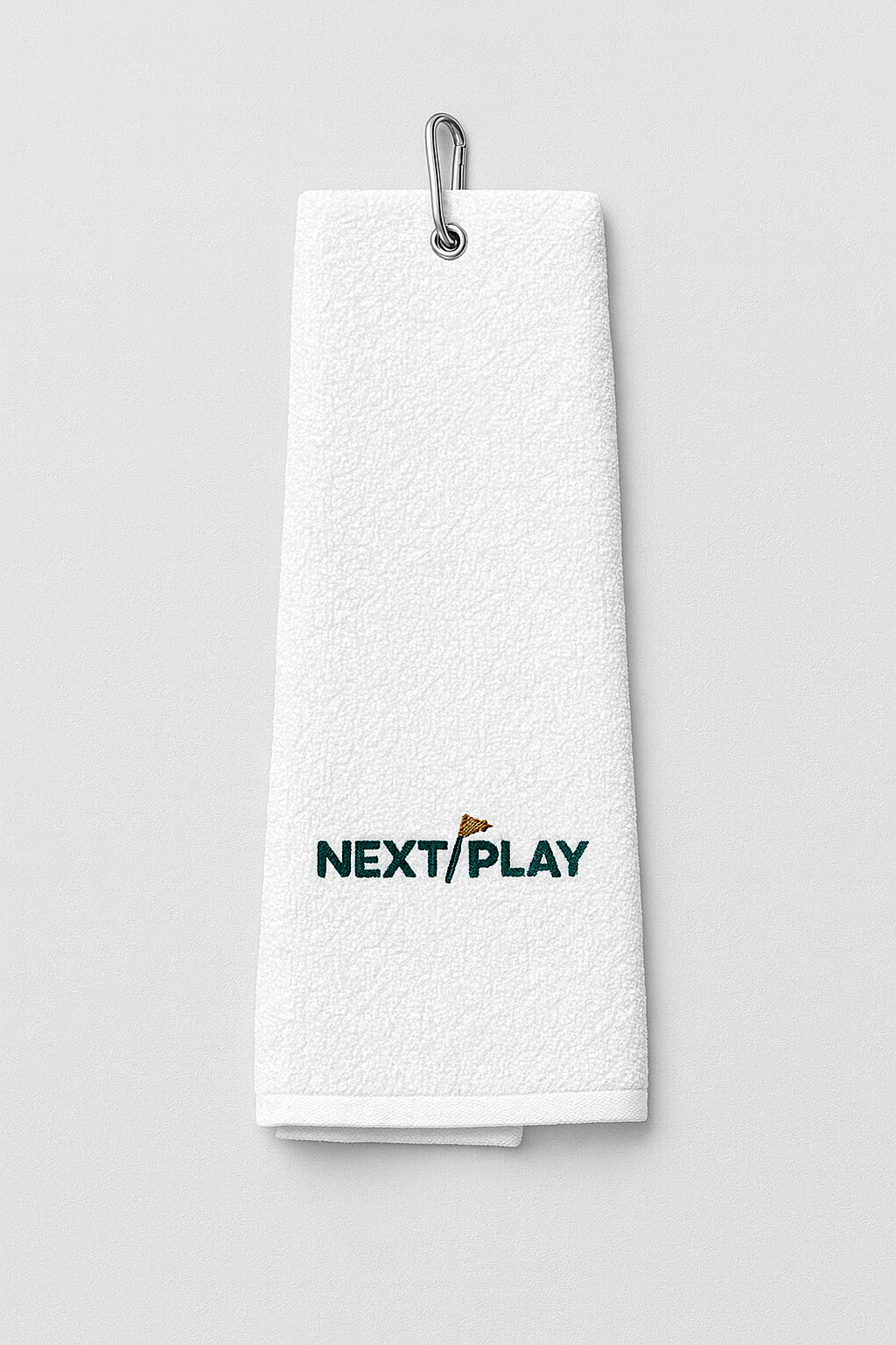 NEXT PLAY Tour Towel — tri-fold cotton golf towel with carabiner clip and tonal embroidery